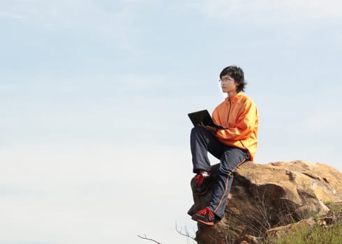 asain Man with notebook at day