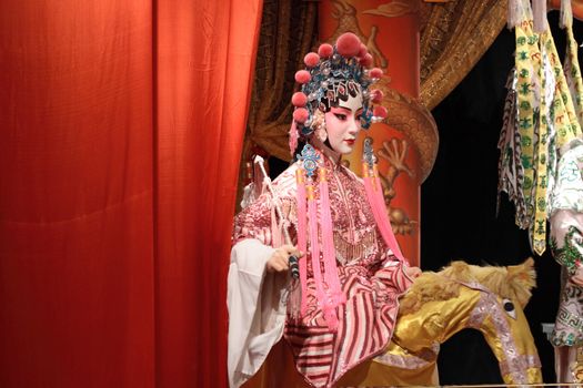 chinese opera dummy and red cloth as text space ,it is a toy,not real man 