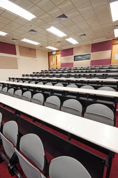 Empty hall for presentation with grey armchairs 