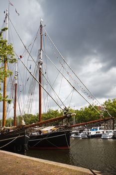 Two old sailingships on rainy and stormy day in harbour