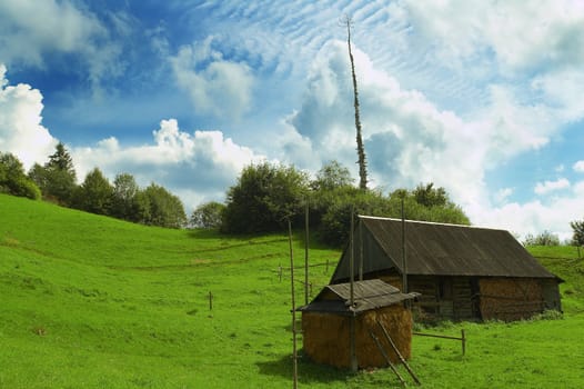 Rural house and stack under impressive clouds