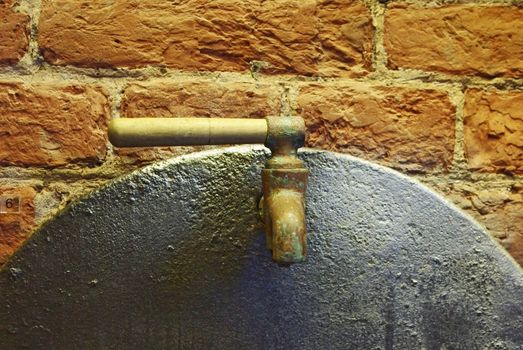 Close up of old water tap over brick wall