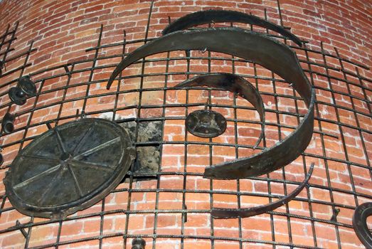 Decorative iron works on weathered brick wall