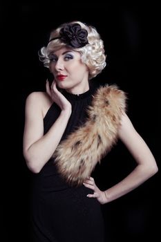 Retro-styled woman with boa over black