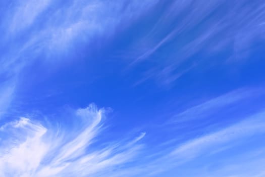 Stratospheric elongated clouds against blue sky background