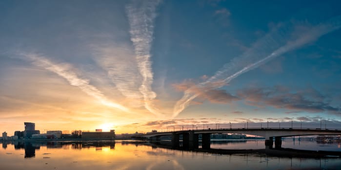 Beautiful panoramic sunrise in city over old historic bridge