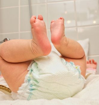 Infant on it's back, having a diaper change