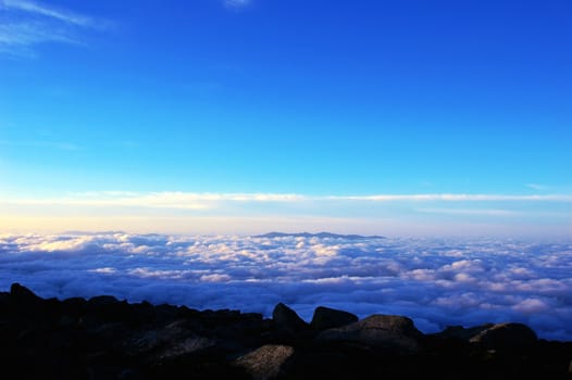 Cloudscape on the top of the mountains at sunrise