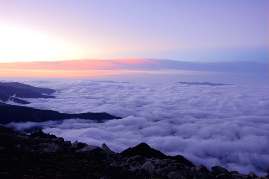 Cloudscape on the top of the mountains at sunrise