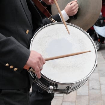 musician of orchestra playing the drum in procession