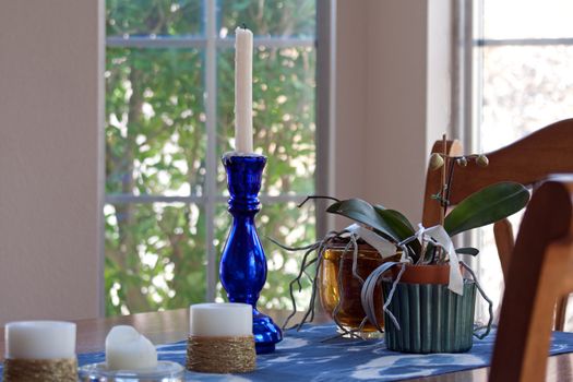 blue candle holder on dining table with chairs