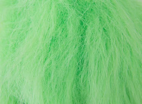 Closeup picture of green fake hair on a doll