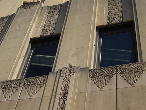 A photograph of a skyscraper detailing its architecture and window pattern.