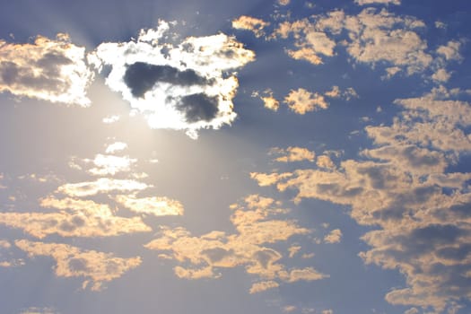 beautiful cloudy dark blue sky and the sun closed by cumulus clouds