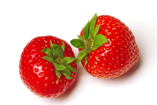Two appetizing brightly red strawberries on a white background