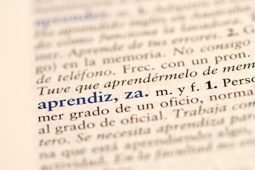 Closeup of spanish dictionary word for apprentice