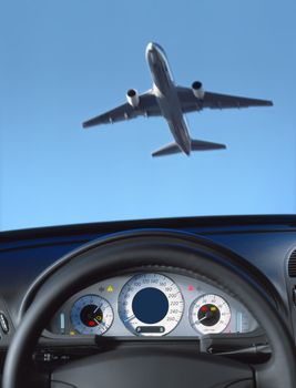 Wheel and dashboard of a car and view through the windshield on the aircraft
