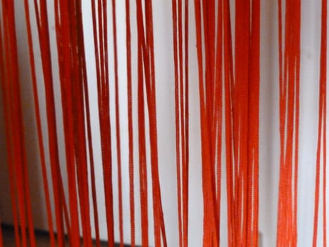 red strings against a white background