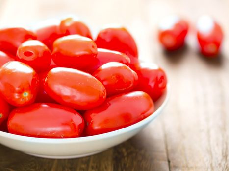 close up of a bowl of roma tomatoes