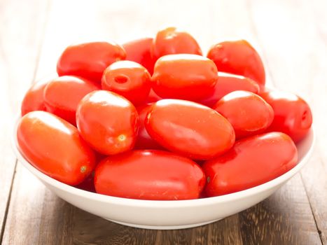 close up of a bowl of roma tomatoes