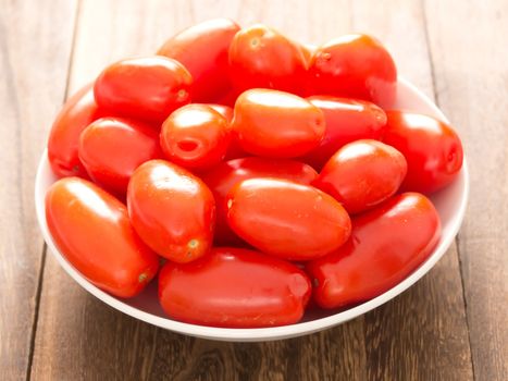 close up of a bowl of roma tomatoes