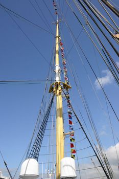 Mast of a sailing vessel with different alarm flags about calling in port of a city of the city Tallinn,  country Estonia