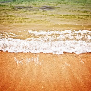 surf on a beach with yellow sand