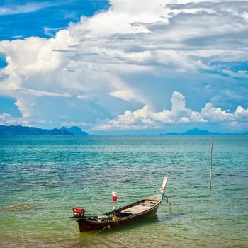 traditional thai long boat on beach in Thailand