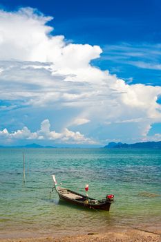 traditional thai long boat on beach in Thailand