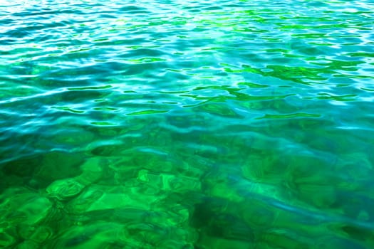 green sea with small waves at sunny day