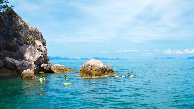 people snorkeling in Andaman Sea, Thailand, at sunny day