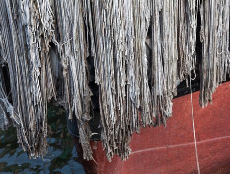 Detail of a rope fender on prow of boat to protect against collision