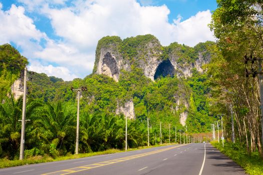 asphalt highway in jungle wit mount, Krabi, Thailand