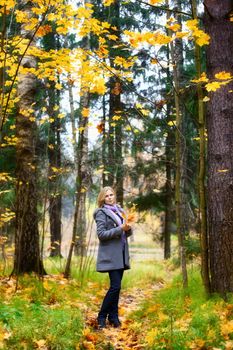 beautiful smiling blond girl in autumn park