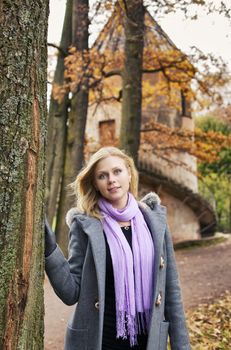 beautiful smiling blond girl in autumn park