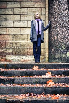 beautiful sad blond girl in autumn park