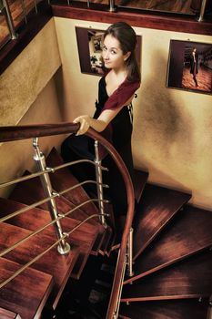 young beautiful lady walk up on stairway in luxury interior