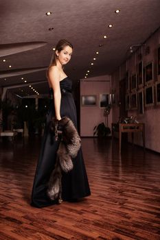 young beautiful lady standing at luxury interior
