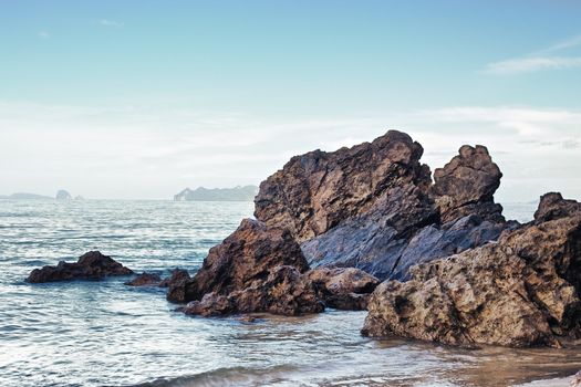 sea with brown rocks at sunny day