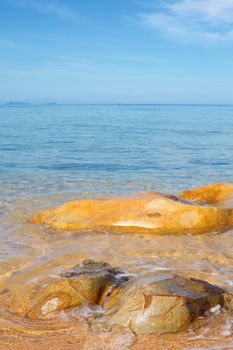 transparent sea with big stone at sunny day