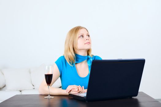 charming woman sitting at the table with laptop