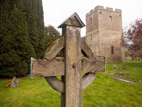 Ancient wooden cross in cemetery of old parish church of Stokesay in Shropshire