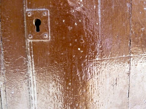 old wooden door with a keyhole