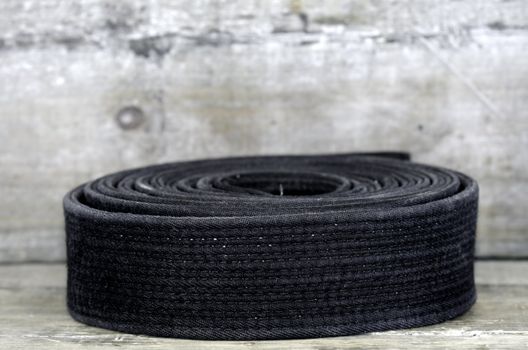 a black belt on wooden background
