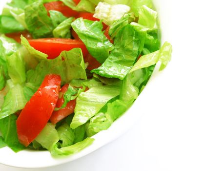 Healthy vegetarian Salad on the white plate over white 