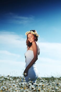 beautiful girl  in dress on the daisy flowers field 