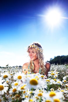  beautiful girl  in dress on the sunny daisy flowers field 