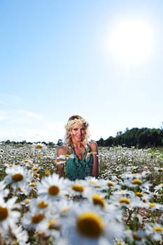  beautiful girl  in dress on the sunny daisy flowers field 