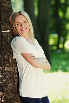 girl standing next to a tree portrait