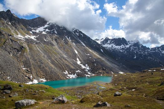 Alpine lake at base of rugged mountain